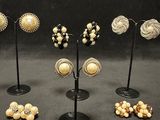a lot of different types of earrings on display