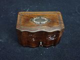 a small wooden box on a black surface