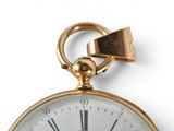 a gold pocket watch with roman numerals on it