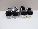 three pairs of black and white shoes are lined up on a white surface