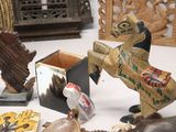 a table topped with assorted items such as a horse, clock, and other items