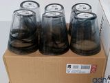 six empty plastic cups sitting on top of a cardboard box