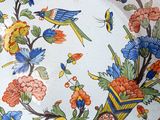 a colorful plate with birds and flowers on it