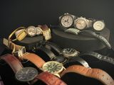 a lot of watches that are sitting on a table