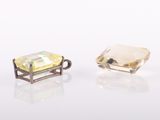 pair of yellow topazte and white topazte earrings on a white surface