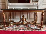 a table with a marble top on a red carpet