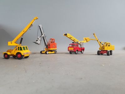 five toy trucks that are lined up in a row