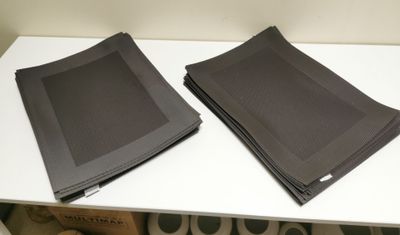 two napkins on a white table next to each other
