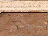 a close up of a piece of wood with writing on it