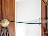a glass shelf with a mirror on top of it