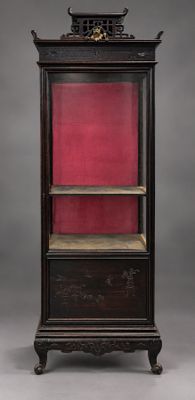 an antique wooden bookcase with red velvet lining the shelves