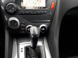 a car dashboard with a gear lever and a dash button