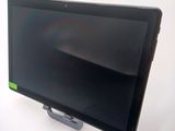 a tablet computer sitting on a stand on a white surface