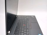 a laptop computer sitting on a table with a keyboard