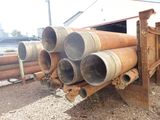 a pile of pipes that are stacked up on the ground