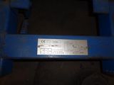 a close up of a blue machine with a metal plate on it