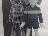 une photo d'une poupée Kaws Chul-Su à côté d'un livre
