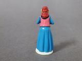 a small figurine of a woman in a blue dress