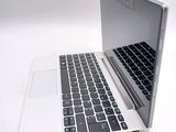 a white laptop with a black keyboard on a white surface