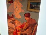 a picture of a person holding a picture of a man in bed