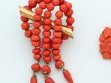 two pieces of jewelry that are on a white surface