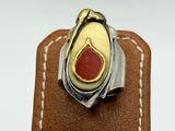 a close up of a ring on a brown leather box