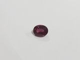 an oval cut pink tourmaline gems on a white surface