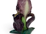 a figurine of a purple flower on a white background