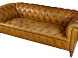brown leather sofa with buttoned arms and legs