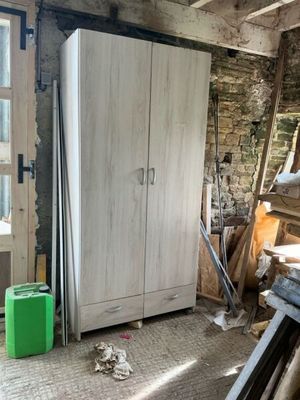 a refrigerator in the middle of a room with a lot of wood