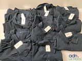 beaucoup de t-shirts posés sur une table, avec leurs étiquettes
