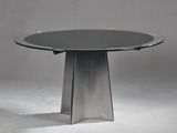 une table en verre avec un piètement en métal posée sur un sol blanc