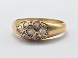 a close up of a gold ring with three diamonds on it