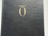 un livre noir ouvert, avec un logo doré sur la couverture