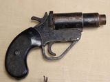 a gun that is sitting on a table next to a pair of scissors