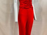 the mannequin is wearing a red jumpsuit and a white top