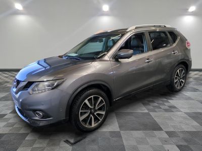 a gray nissan suv parked in a garage with a checkered floor