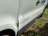 a white van that has been badly damaged by a car accident