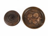 two wooden bowls with carvings on them sitting on a white surface