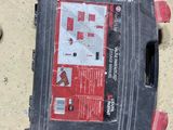 a black box with a red label on it sitting on the floor