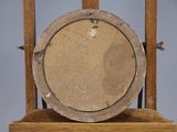 a clock that is sitting on top of a wooden stand