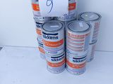 several cans of paint are stacked on top of each other