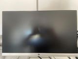 a computer monitor sitting on top of a desk next to a keyboard and mouse