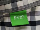 a close up of a shirt with a green label on it