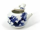 a blue and white teapot with a lid on a white surface