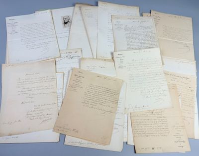 several old papers are piled on top of each other on a table