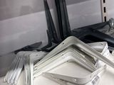 several pieces of metal sit on top of a shelf in a kitchen