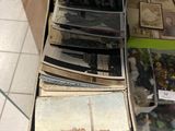 a person holding a stack of old photos in a box