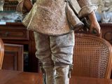 a statue of a man with a hat on a table