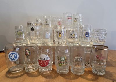 a lot of beer glasses sitting on a table